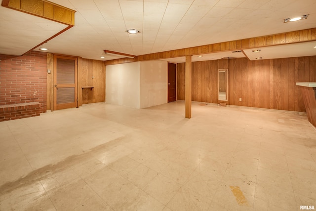 1427 35th Ave, Rock Island, IL 61201 - finished below grade area featuring tile patterned floors, wood walls, brick wall, and recessed lighting