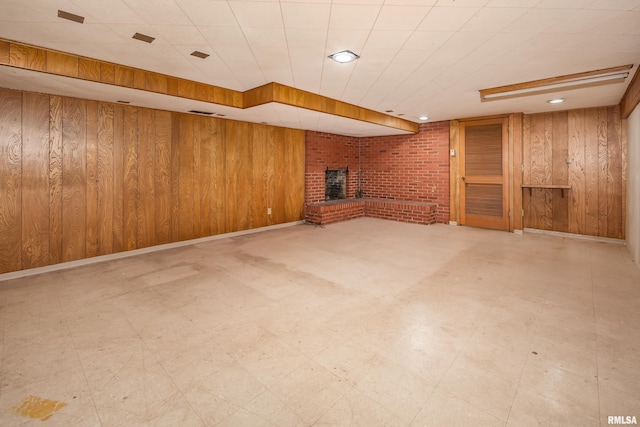 1427 35th Ave, Rock Island, IL 61201 - finished below grade area featuring a fireplace, wooden walls, and tile patterned floors