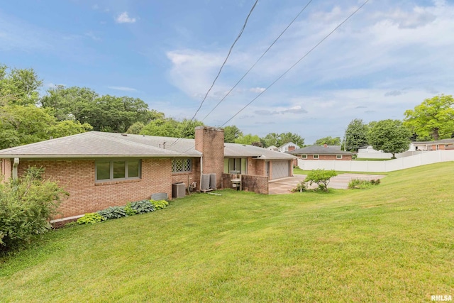 1427 35th Ave, Rock Island, IL 61201 - rear view of house with brick siding, a chimney, and a shingled roof