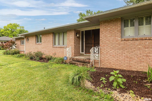 1427 35th Ave, Rock Island, IL 61201 - property entrance with a lawn and brick siding