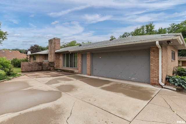 1427 35th Ave, Rock Island, IL 61201 - view of front of home with driveway, brick siding, an attached garage, and a chimney