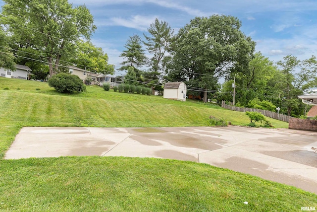 1427 35th Ave, Rock Island, IL 61201 - view of yard featuring a storage unit and a patio area