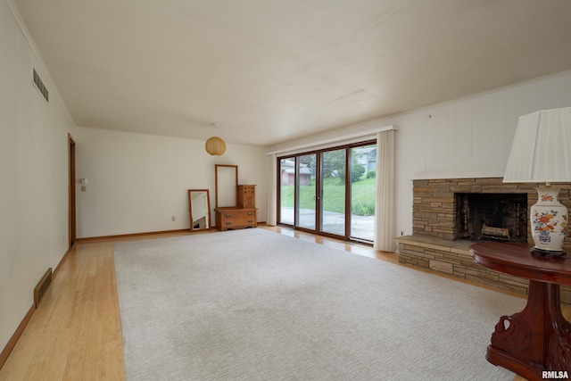1427 35th Ave, Rock Island, IL 61201 - unfurnished living room featuring light wood finished floors and a fireplace