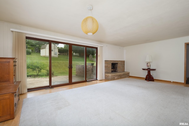 1427 35th Ave, Rock Island, IL 61201 - unfurnished living room featuring light wood-style floors and a stone fireplace