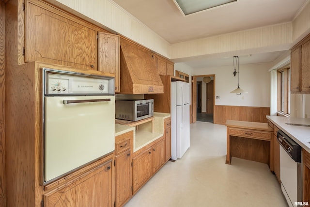 1427 35th Ave, Rock Island, IL 61201 - kitchen with white appliances, a wainscoted wall, light countertops, hanging light fixtures, and wooden walls