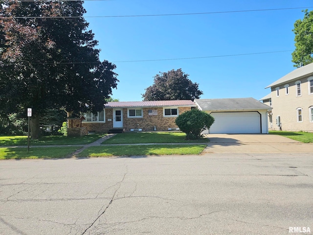 509 W 9th St, Tipton, IA 52772 - view of front of property with concrete driveway, a front lawn, and a garage