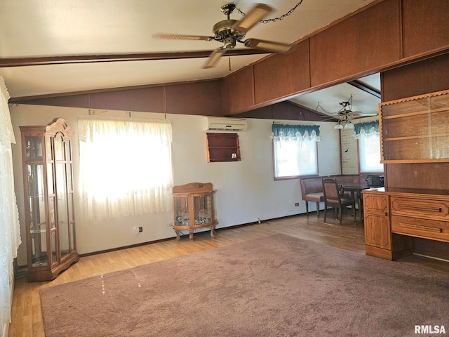 509 W 9th St, Tipton, IA 52772 - interior space with light wood-style flooring, a wall mounted AC, and a ceiling fan