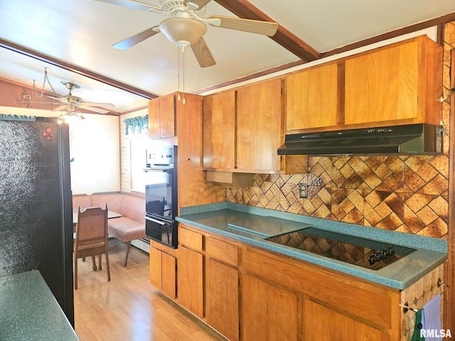 509 W 9th St, Tipton, IA 52772 - kitchen featuring black appliances, under cabinet range hood, ceiling fan, light wood-type flooring, and backsplash
