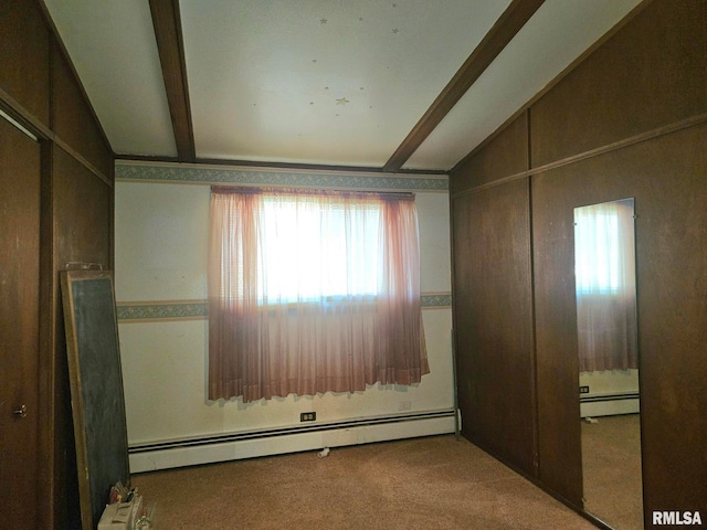 509 W 9th St, Tipton, IA 52772 - carpeted empty room featuring baseboard heating, healthy amount of natural light, and beamed ceiling