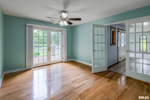 10415 Chayla Rd, Marion, IL 62959 - empty room with french doors, light wood-type flooring, and a ceiling fan