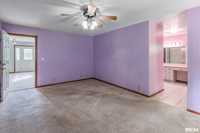10415 Chayla Rd, Marion, IL 62959 - spare room with light carpet, ceiling fan, and light tile patterned floors
