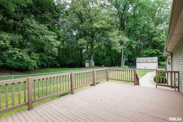 10415 Chayla Rd, Marion, IL 62959 - deck with a storage unit, a fenced backyard, and view of wooded area