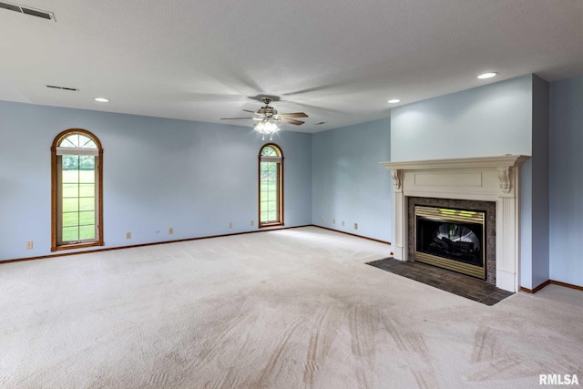 10415 Chayla Rd, Marion, IL 62959 - unfurnished living room featuring carpet floors, a ceiling fan, a high end fireplace, plenty of natural light, and recessed lighting