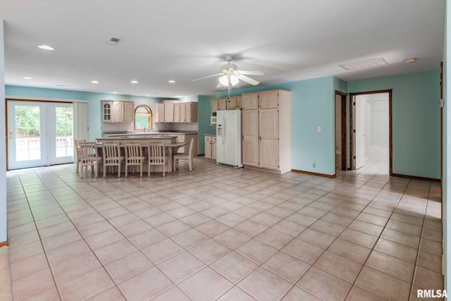 10415 Chayla Rd, Marion, IL 62959 - kitchen with white fridge with ice dispenser, a kitchen breakfast bar, a ceiling fan, recessed lighting, and glass insert cabinets