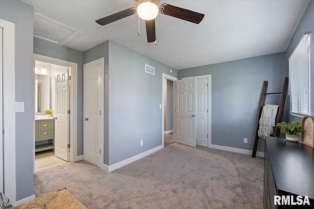 3518 W Garfield St, Davenport, IA 52804 - unfurnished bedroom featuring light carpet, ensuite bathroom, a ceiling fan, and attic access