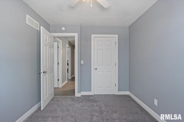 3518 W Garfield St, Davenport, IA 52804 - unfurnished bedroom with a textured ceiling, carpet floors, and ceiling fan