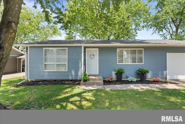 3518 W Garfield St, Davenport, IA 52804 - view of front of property with a front yard and a garage