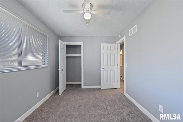 3518 W Garfield St, Davenport, IA 52804 - unfurnished bedroom with carpet, a textured ceiling, a closet, and ceiling fan