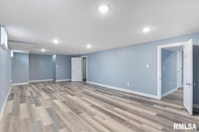 3518 W Garfield St, Davenport, IA 52804 - finished below grade area with light wood-style flooring, recessed lighting, and a textured ceiling