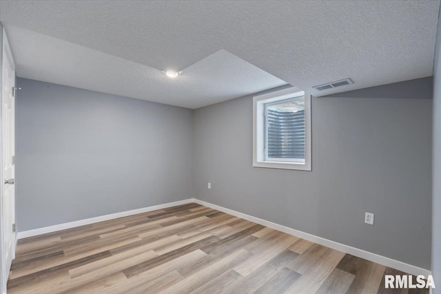 3518 W Garfield St, Davenport, IA 52804 - unfurnished room with wood finished floors and a textured ceiling