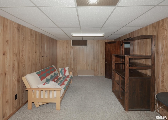 3536 W Hayes St, Davenport, IA 52804 - sitting room featuring wooden walls, a paneled ceiling, and carpet floors