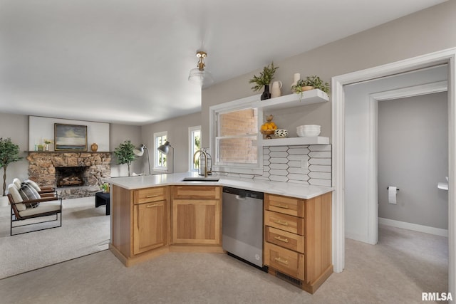 922 W Lombard St, Davenport, IA 52804 - kitchen with stainless steel dishwasher, a fireplace, open floor plan, light countertops, and open shelves