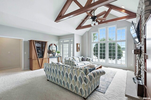 21945 Great River Rd, Le Claire, IA 52753 - living room with carpet flooring, beamed ceiling, a ceiling fan, and high vaulted ceiling