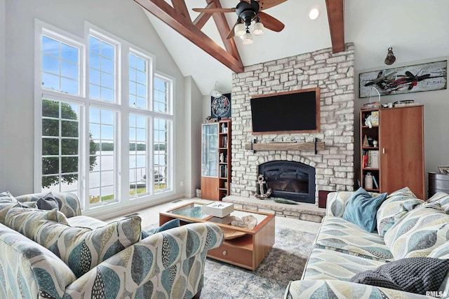 21945 Great River Rd, Le Claire, IA 52753 - living room featuring high vaulted ceiling, a ceiling fan, beam ceiling, plenty of natural light, and a fireplace