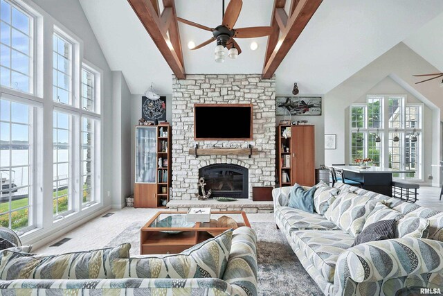 21945 Great River Rd, Le Claire, IA 52753 - living room with ceiling fan, healthy amount of natural light, a water view, high vaulted ceiling, and beamed ceiling