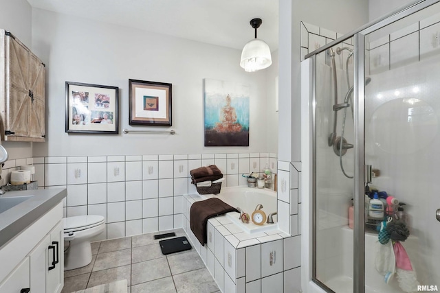 21945 Great River Rd, Le Claire, IA 52753 - bathroom with vanity, a jetted tub, a shower stall, tile patterned flooring, and tile walls
