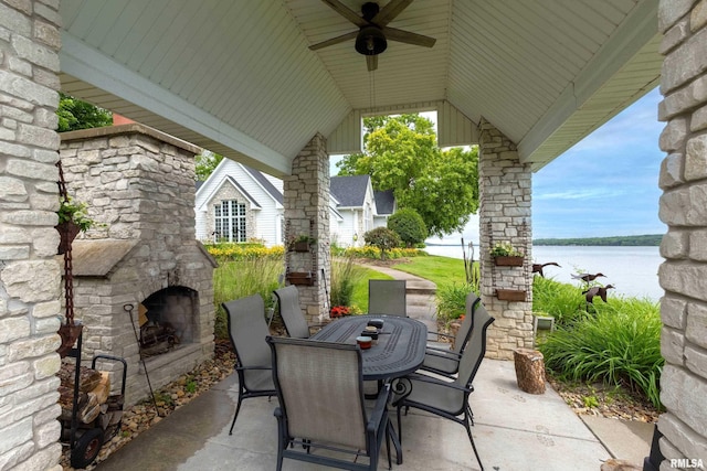 21945 Great River Rd, Le Claire, IA 52753 - view of patio featuring an outdoor stone fireplace, outdoor dining space, a water view, and ceiling fan