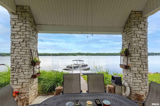 21945 Great River Rd, Le Claire, IA 52753 - view of patio featuring outdoor dining area, a water view, and a boat dock