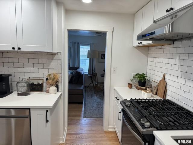 224 S Henderson St, Toulon, IL 61483 - kitchen featuring range with gas cooktop, under cabinet range hood, stainless steel dishwasher, light wood-style flooring, and tasteful backsplash