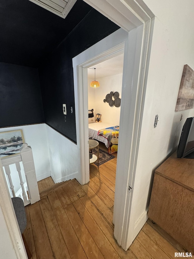 224 S Henderson St, Toulon, IL 61483 - corridor with light wood-style floors and an upstairs landing