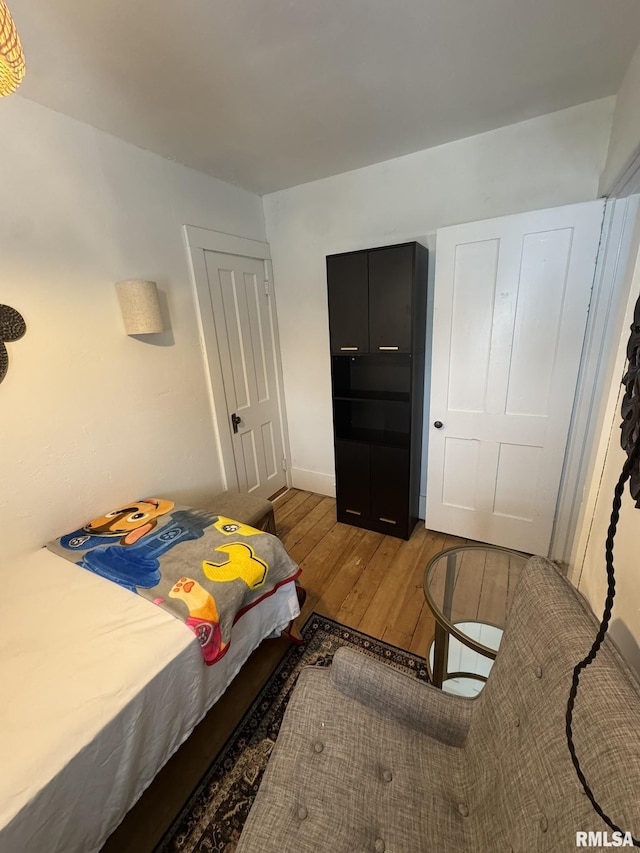 224 S Henderson St, Toulon, IL 61483 - bedroom with hardwood / wood-style flooring and baseboards