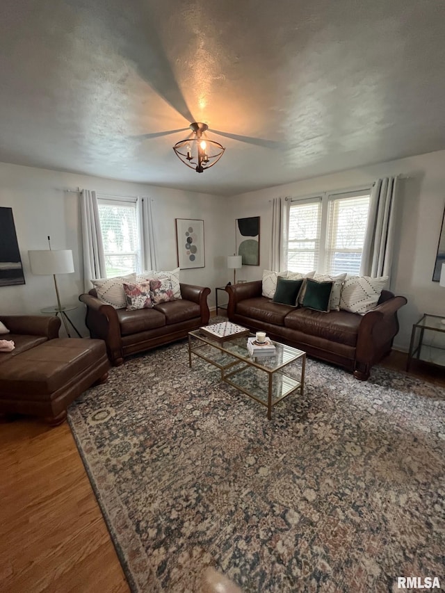 224 S Henderson St, Toulon, IL 61483 - living room with wood finished floors and a chandelier
