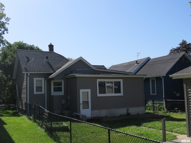 312 N 3rd St, Clinton, IA 52732 - view of home's exterior with a chimney and a shingled roof
