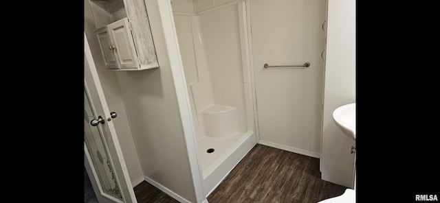 911 4th St, New Boston, IL 61272 - bathroom with wood finished floors, a shower stall, and vanity