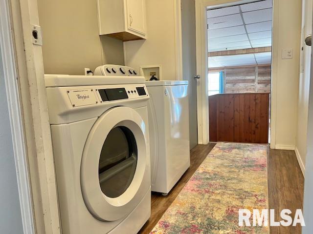 911 4th St, New Boston, IL 61272 - washroom featuring cabinet space, independent washer and dryer, and dark wood-style flooring