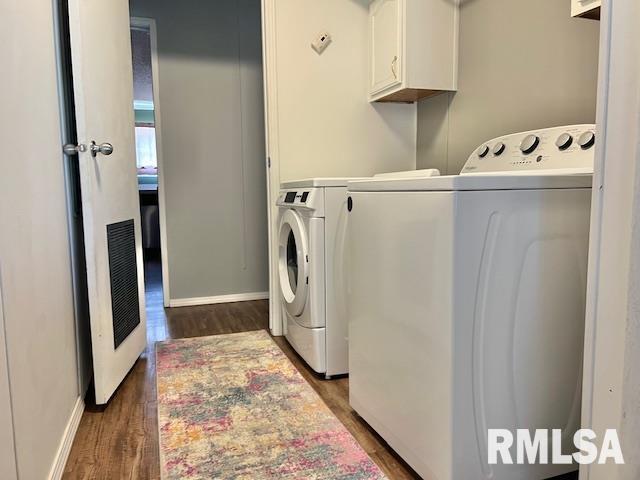 911 4th St, New Boston, IL 61272 - laundry room featuring cabinet space, independent washer and dryer, and dark wood-style floors