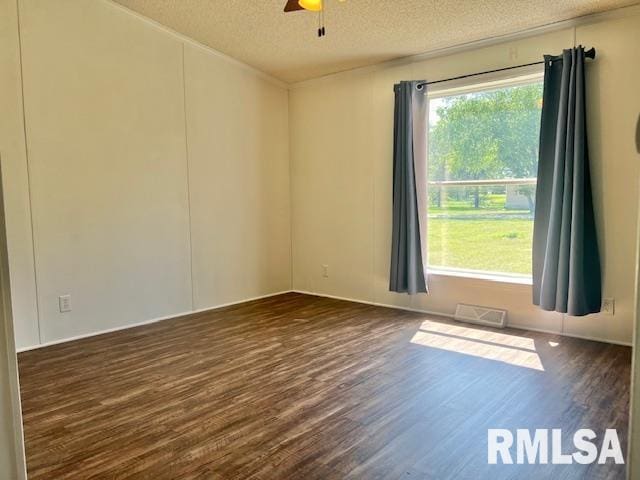 911 4th St, New Boston, IL 61272 - empty room featuring dark wood-style flooring, a textured ceiling, and a ceiling fan