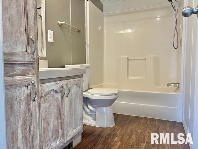 911 4th St, New Boston, IL 61272 - bathroom featuring vanity, wood finished floors, and shower / bathtub combination
