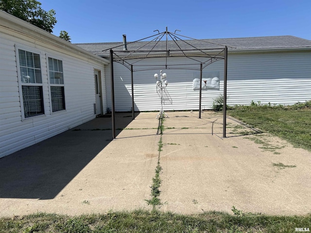 911 4th St, New Boston, IL 61272 - view of patio / terrace with a gazebo