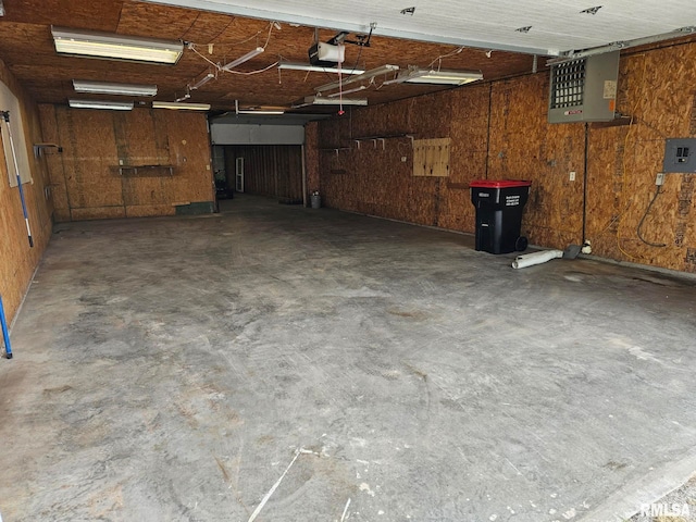 911 4th St, New Boston, IL 61272 - garage featuring a garage door opener and wooden walls