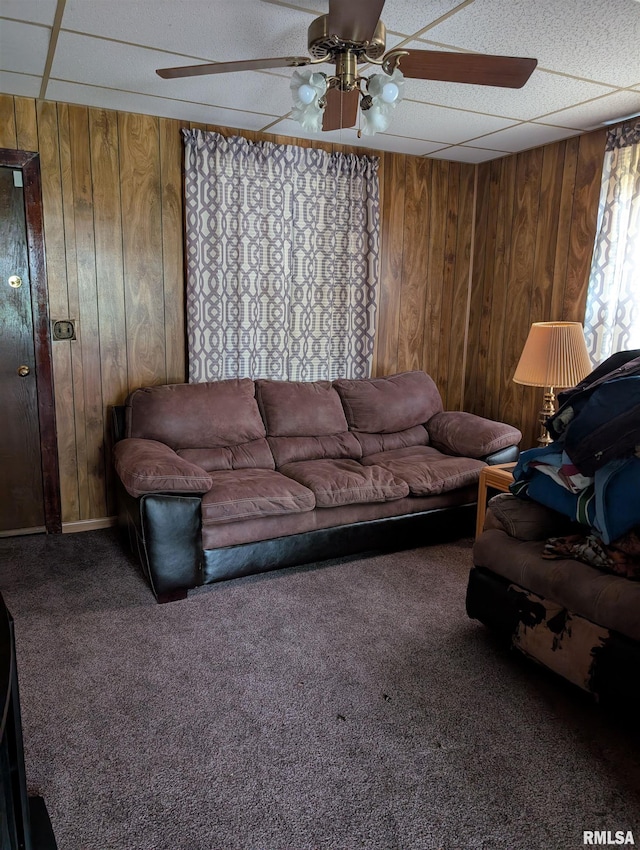 1507 N Lincoln Ave, Davenport, IA 52804 - living room featuring a ceiling fan, wooden walls, and carpet
