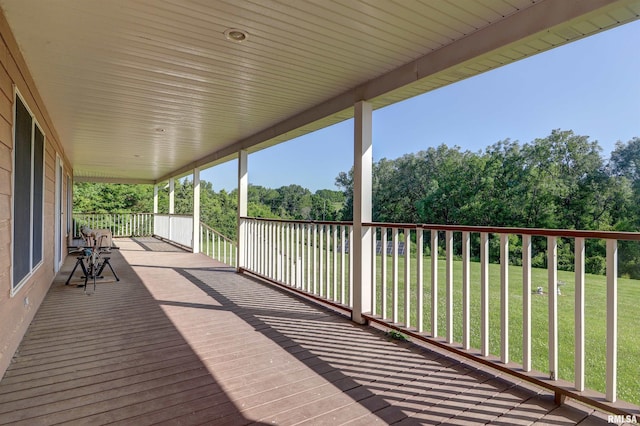 4581 180th St, Clinton, IA 52732 - wooden terrace with a lawn and view of wooded area