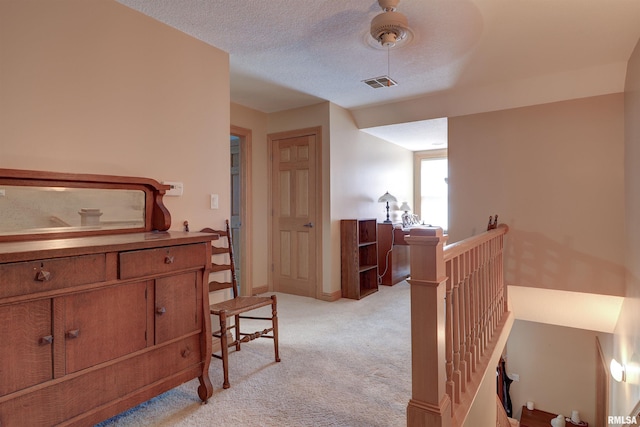 4581 180th St, Clinton, IA 52732 - corridor featuring an upstairs landing, light carpet, and a textured ceiling