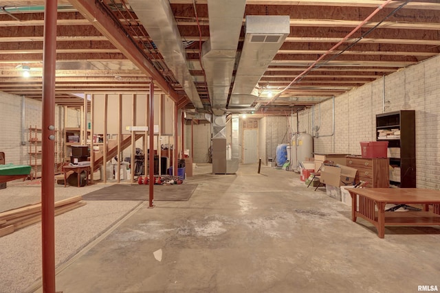 4581 180th St, Clinton, IA 52732 - unfinished basement with brick wall, electric water heater, and heating unit