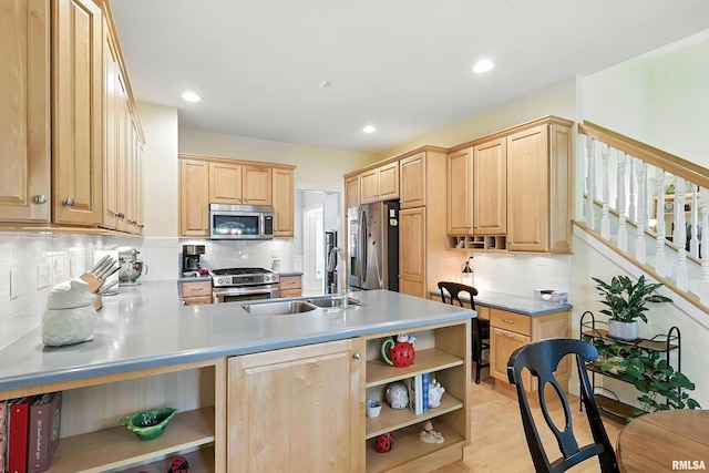 905 Bridgeview Place, Le Claire, IA 52753 - kitchen with open shelves, stainless steel appliances, light brown cabinets, decorative backsplash, and a peninsula