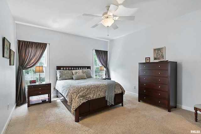 905 Bridgeview Place, Le Claire, IA 52753 - bedroom featuring multiple windows, light colored carpet, and a ceiling fan